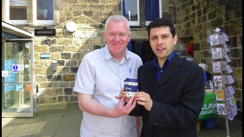 Otley Green Fair 2019. Alex Sobel MP and Ray Georgsson Leader of the Otley Council holding reusable coffee mugs at the Green Fair 2018.